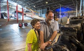 Man and woman looking at machine
